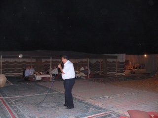 Faisal Hasnain speaking at Al Maha desert event